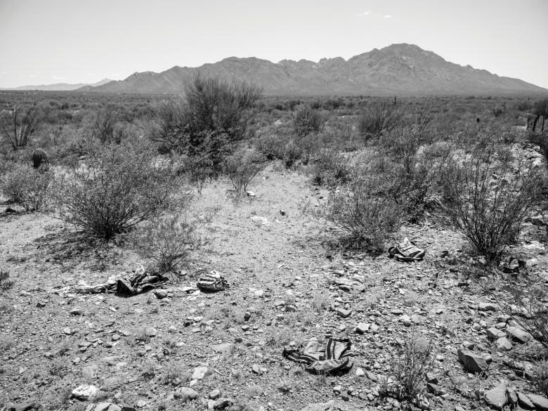 Migrants’ backpacks and other belongings scattered on the ground in the Sonoran Desert near the Tohono O’odham Nation in Arizona.