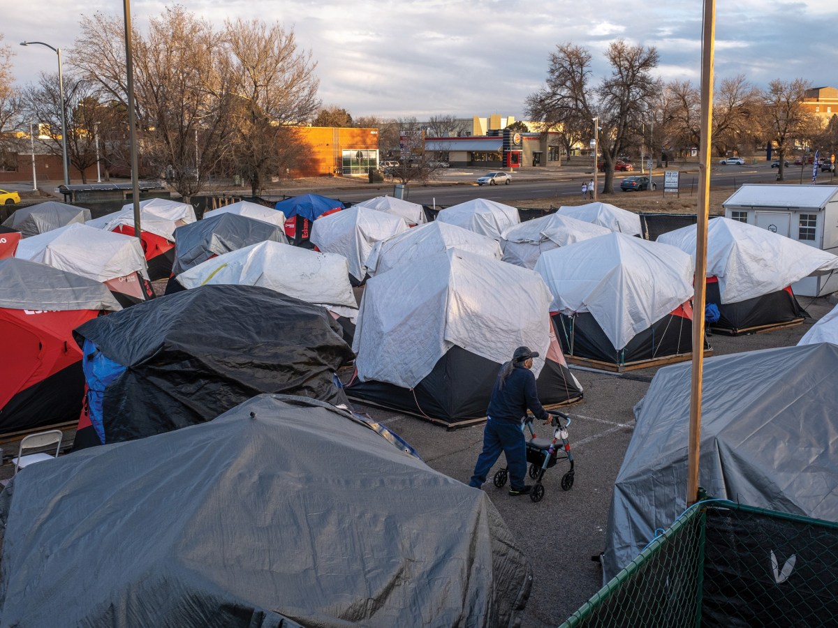 Grant Davis walks back to his tiny home at Colorado Village Collaborative’s Native-Inclusive Safe Outdoor Space in Denver, Colorado.