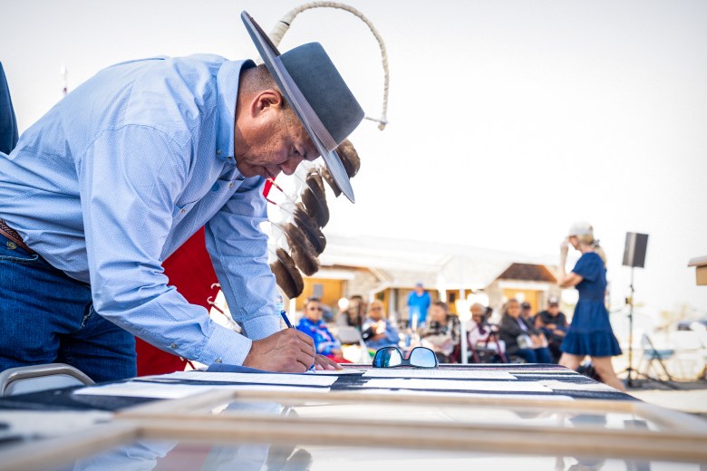 Northern Arapaho Business Council Chairman Lloyd Goggles signs documentation officially receiving over 200 artifacts from the Episcopal Church of Wyoming.