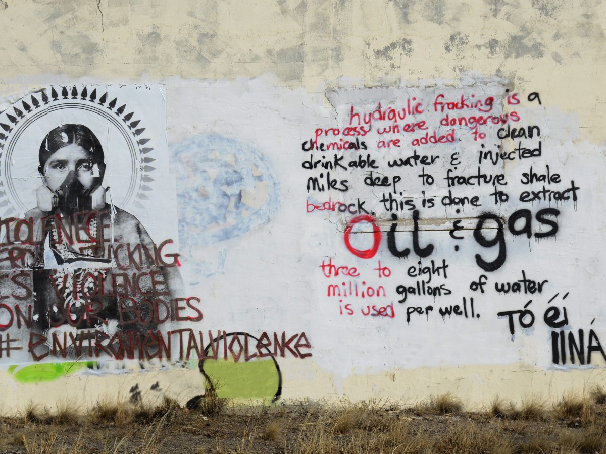 Anti-fracking graffiti on an abandoned house near Bloomfield, New Mexico, near Navajo Nation, expresses opposition to the oil and gas in the area.