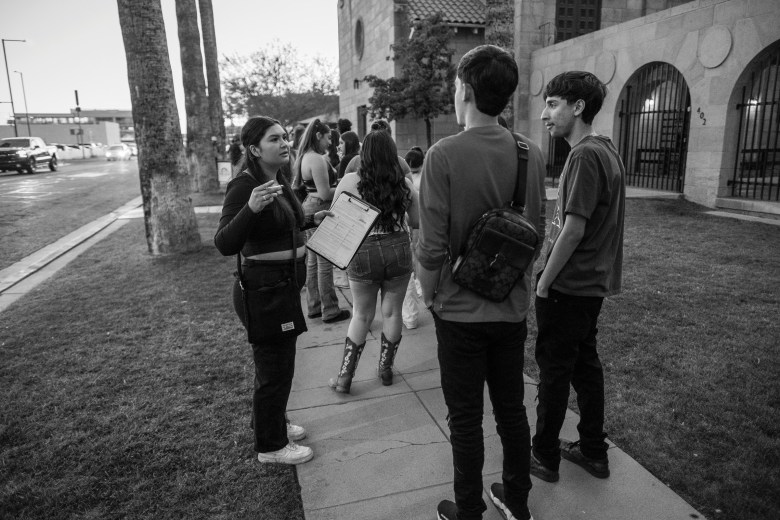 A volunteer with the Arizona Center for Empowerment registers young voters in line for a concert by popular Mexican-American singer-songwriter Xavi, in downtown Phoenix in May.