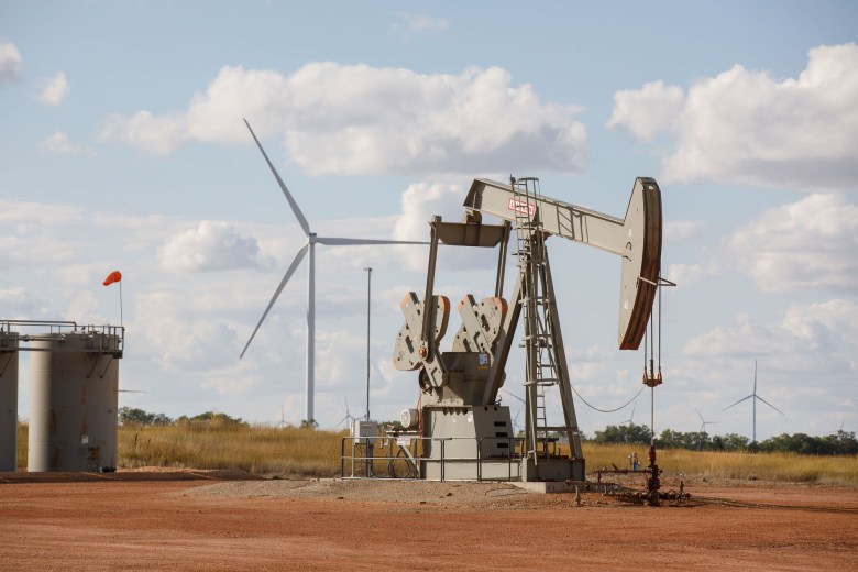 An oil pump jack and wind turbines in Williams County, N.D.