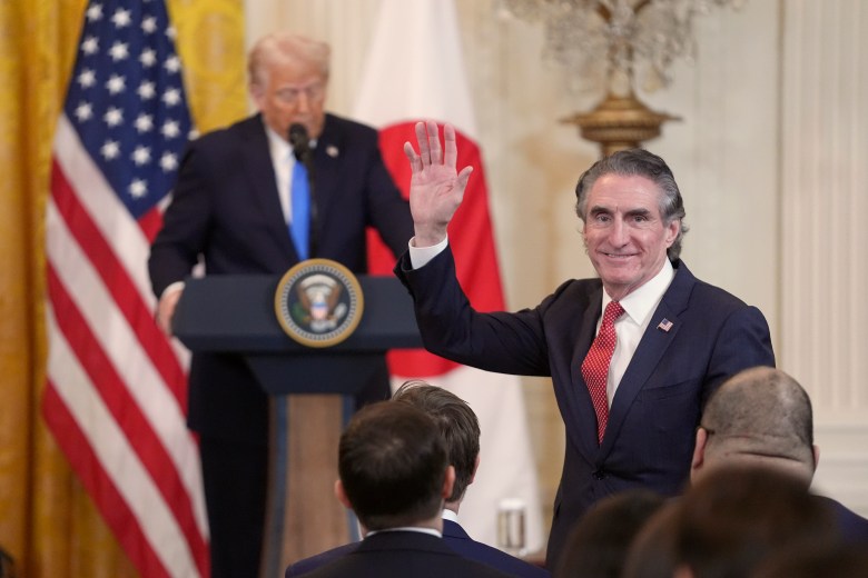 Interior Secretary Doug Burgum waves as President Donald Trump speaks during a news conference.