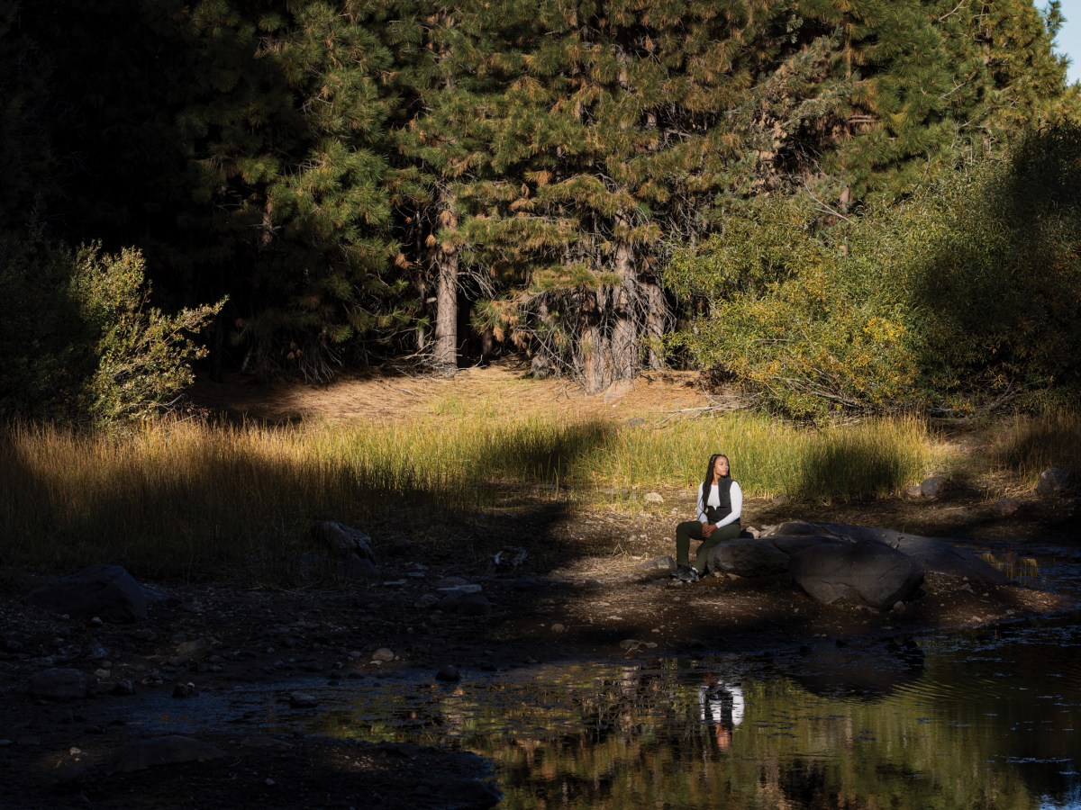 Jade Stevens rests near Lake Putt on land in California’s Tahoe National Forest that is owned and managed by the 40 Acre Conservation League.