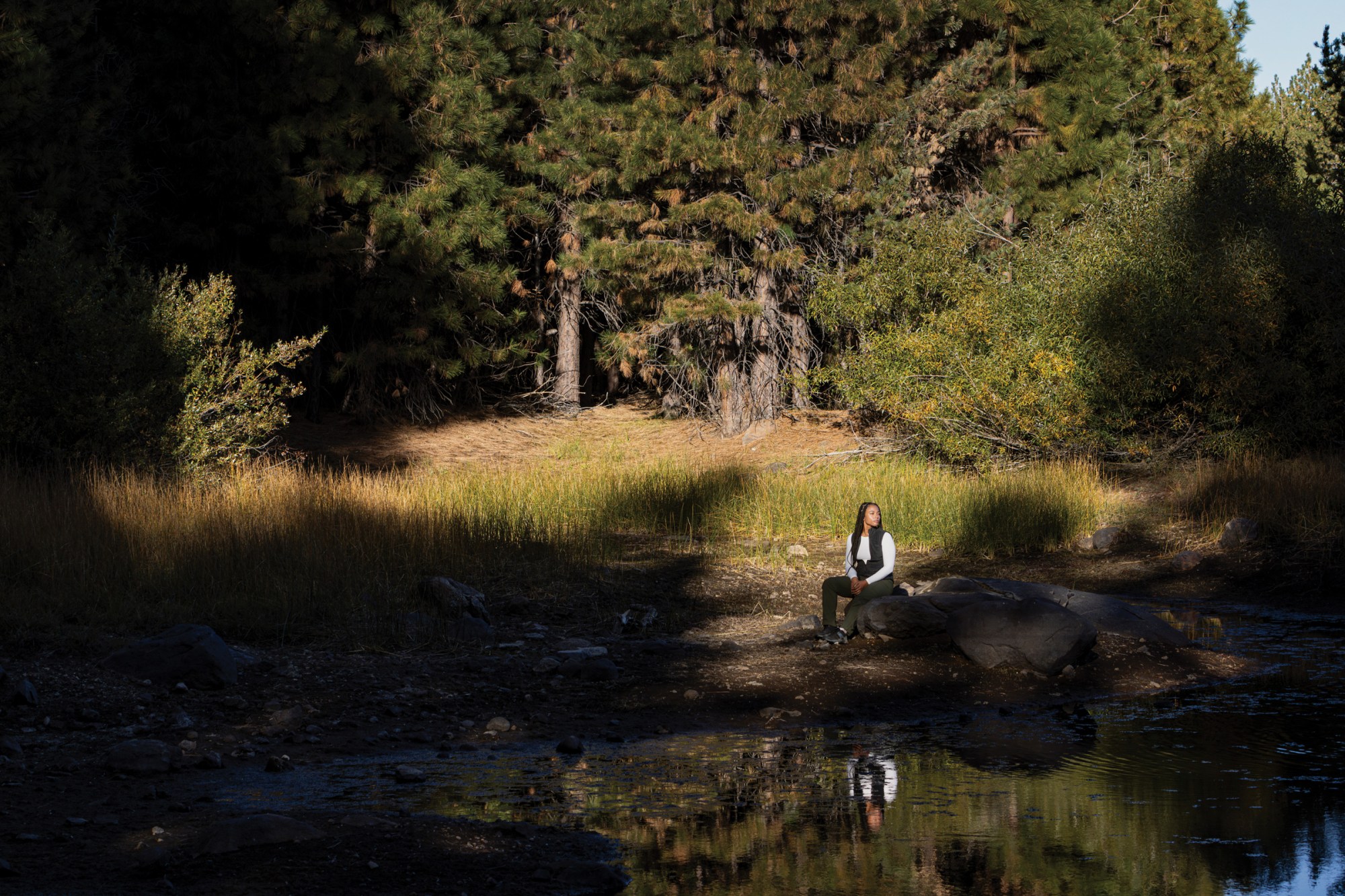 Jade Stevens rests near Lake Putt on land in California’s Tahoe National Forest that is owned and managed by the 40 Acre Conservation League.