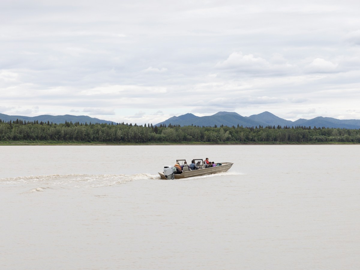 Ryan Madros takes a boat full of children, teens and adults to this year’s culture camp upriver from Ruby, Alaska. Madros and his wife, Rachael Kangas Madros, played key roles in organizing culture camp this year.