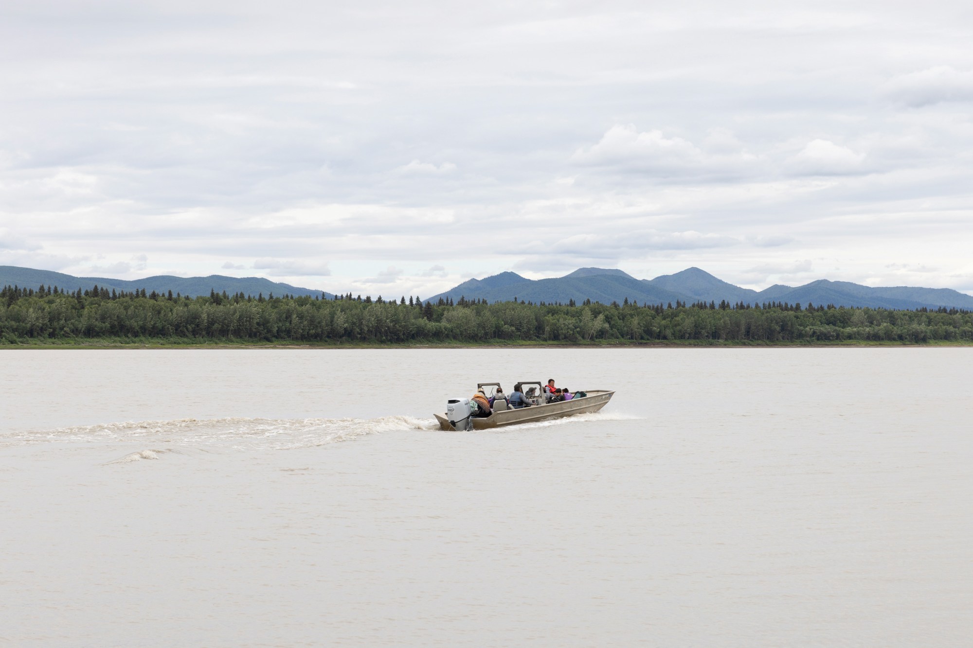 Ryan Madros takes a boat full of children, teens and adults to this year’s culture camp upriver from Ruby, Alaska. Madros and his wife, Rachael Kangas Madros, played key roles in organizing culture camp this year.