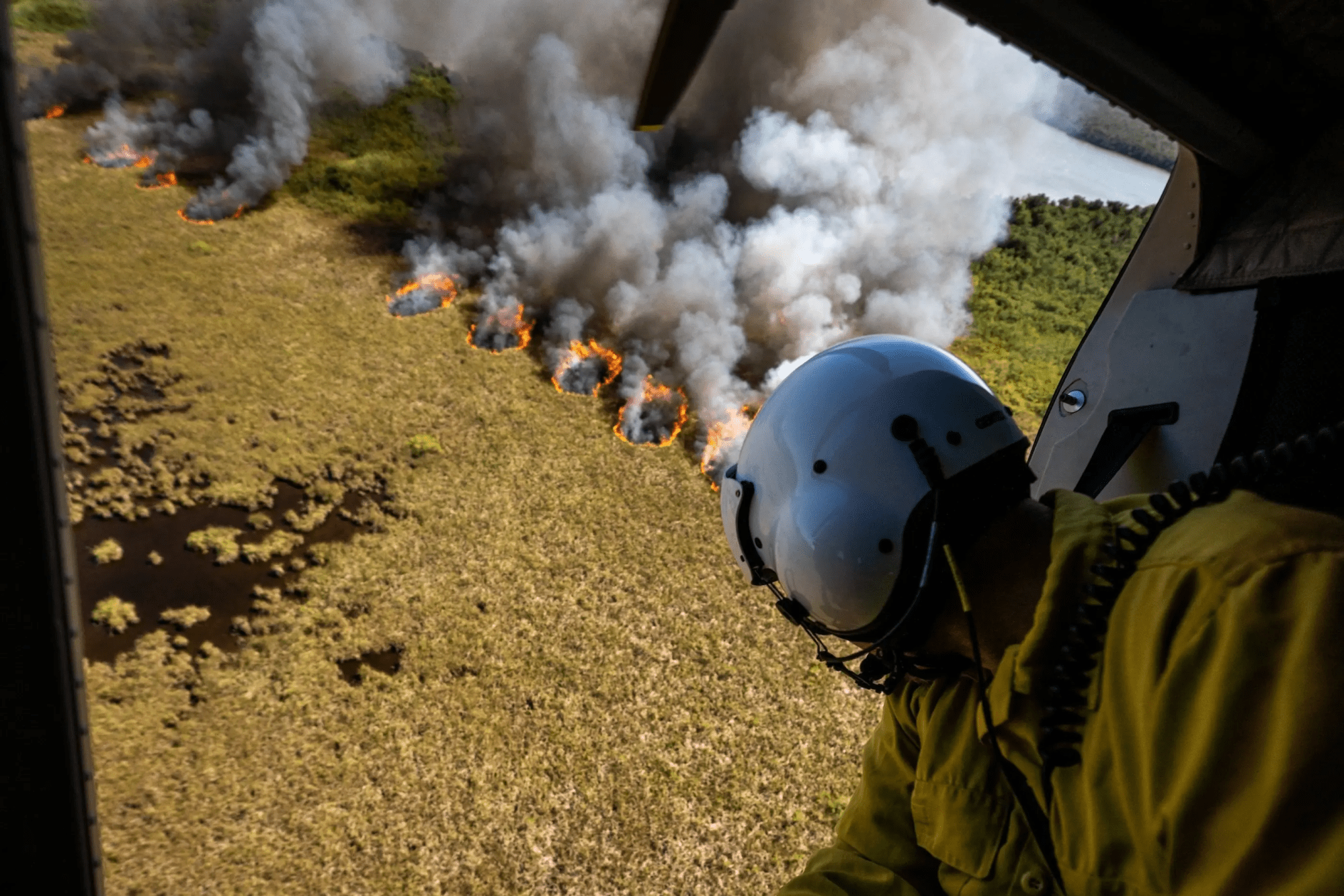 A wildland firefighter observes a prescribed burn in Everglades National Park in 2023. Uncertainty over funding and other interruptions related to President Donald Trump’s executive orders have delayed work to reduce flammable vegetation and other preparations for wildfire season.